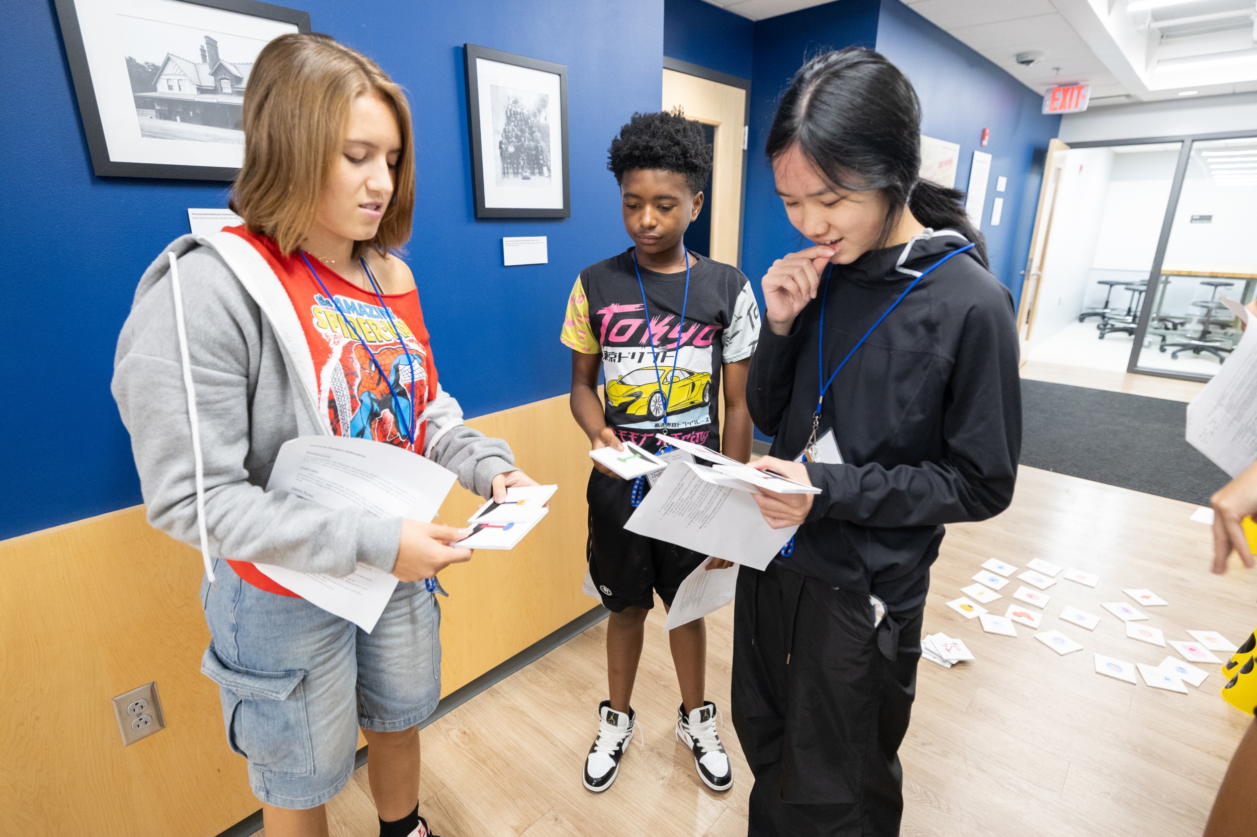 Three Camp BioE participants looking at a handout